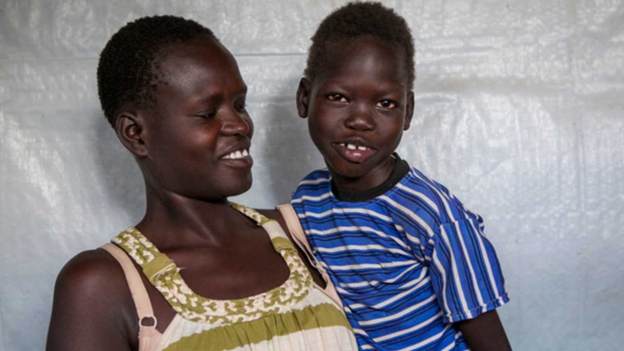 Omot Ochang, a South Sudanses girl with cerebral palsy, and her mother at a refugee reception centre in Kenya, May 2017. 