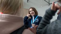 Yevheniia KHORUZHA, HI risk education officer, explains safe behaviour to children through an educational story prepared by HI's Poltava teams.  